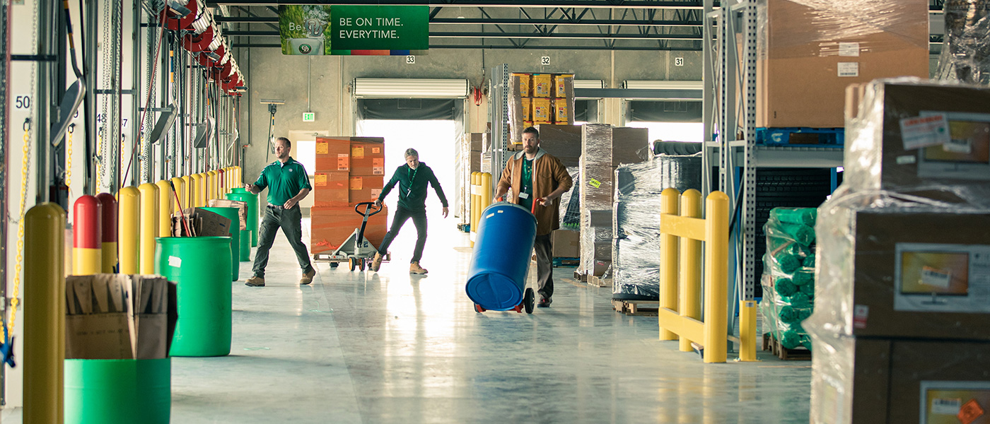 Dockworkers and supervisor loading freight on a dock